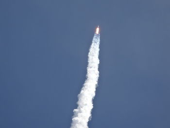 Low angle view of vapor trail against clear blue sky