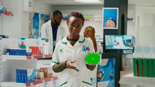 Portrait of female doctor examining x-ray