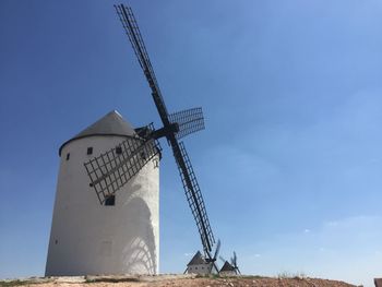 Low angle view of traditional windmill against sky