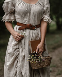 Midsection of woman holding wicker basket