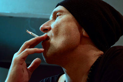 Man smoking cigarette at home