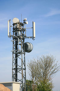 Low angle view of telephone pole against sky