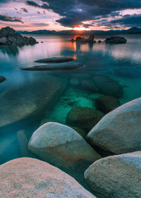 Scenic view of rocks in lake against sky