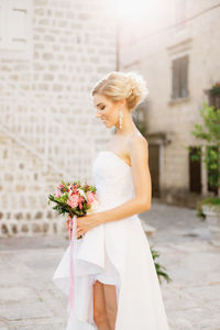 Midsection of woman holding flower bouquet