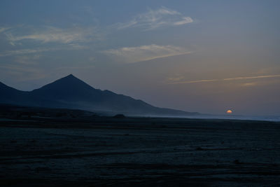 Sunset on cofete beach in fuerteventura in jandia natural park with silhouettes and mountains
