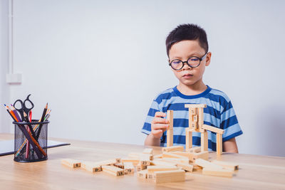 Portrait of boy playing on table