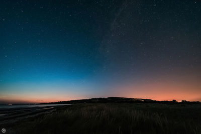 Scenic view of field against sky at night