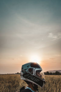 Vintage car on field against sky during sunset