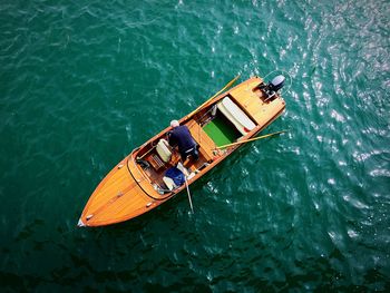 Directly above view of man on motorboat over lake