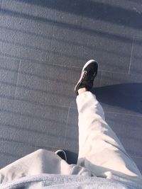 Low section of man walking on footpath
