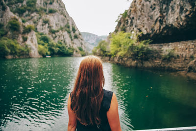 Rear view of woman looking at lake