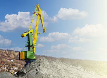 Low angle view of crane against sky