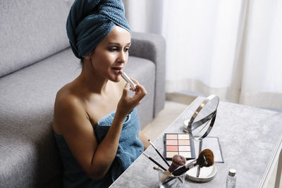 High angle view of woman sitting on table