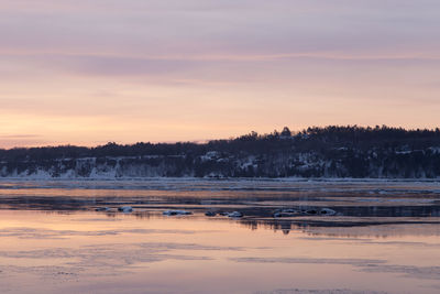 Winter sunrise view of the st. lawrence river with houses on the south shore