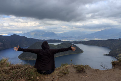 Rear view of woman in lake against sky