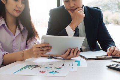 Midsection of woman using mobile phone