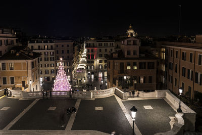 High angle view of illuminated buildings against sky at night
