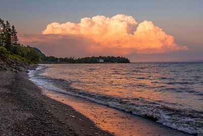 Scenic view of beach against sky during sunset