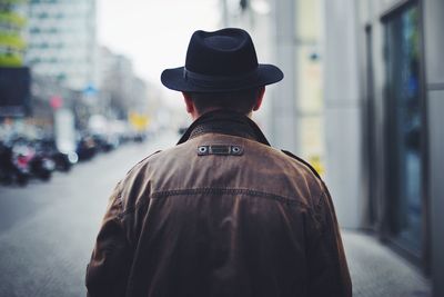 Rear view of man wearing hat and jacket