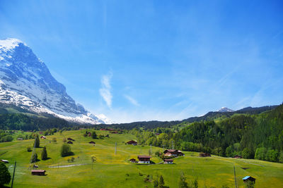 Scenic view of field and mountains against sky