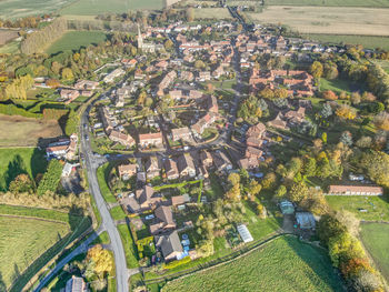 High angle view of trees and houses in field