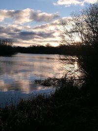 Scenic view of lake against cloudy sky