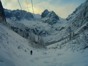 Tourists on snow covered mountain