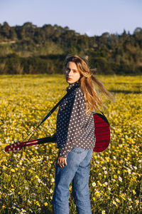 Portrait of woman standing on field