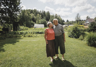 Happy senior couple standing in the garden