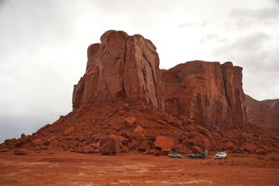 Rock formations on mountain against cloudy sky