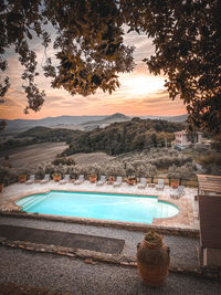 View of swimming pool at sunset