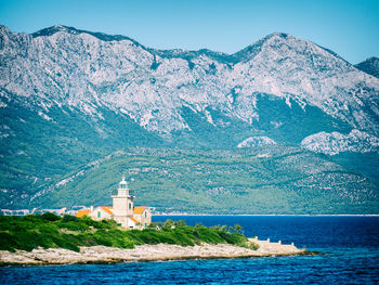 Lighthouse on the tip of the island hvar with view to the mountains on the croatian mainland