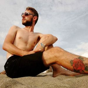 Young man sitting outdoors