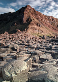 Scenic view of sand dunes against sky
