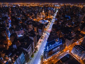 High angle view of illuminated city street and buildings at night