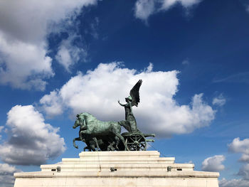 Low angle view of statue against cloudy sky