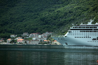 Ferry in sea with house in background