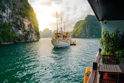 Boats sailing in river against sky