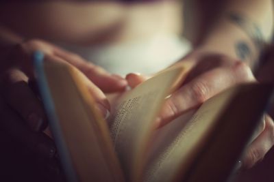 Close-up of woman hand on book