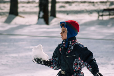 Boy on snow covered field