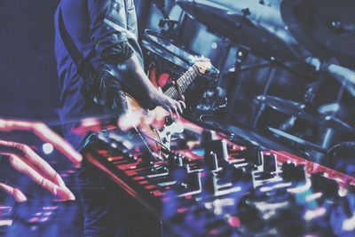 Double exposure image of musicians playing musical instruments on stage