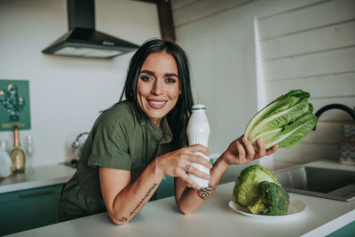 Portrait of woman holding food at home