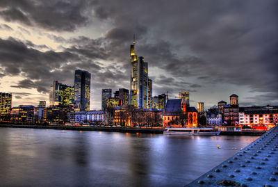 Illuminated buildings in city at dusk