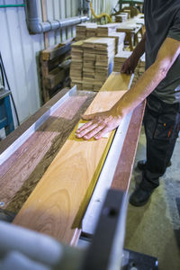 Midsection of man working at workshop