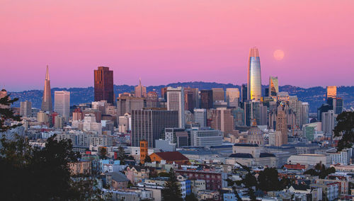 Modern buildings in city against sky during sunset, san francisco