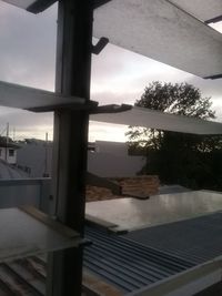 Close-up of swimming pool against window at sunset