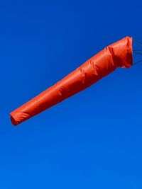 Low angle view of parasol against blue sky