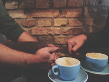 Close-up of hand holding coffee cup