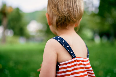 Rear view of woman standing against blurred background