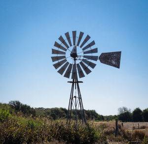 Low angle view of windmill against clear sky